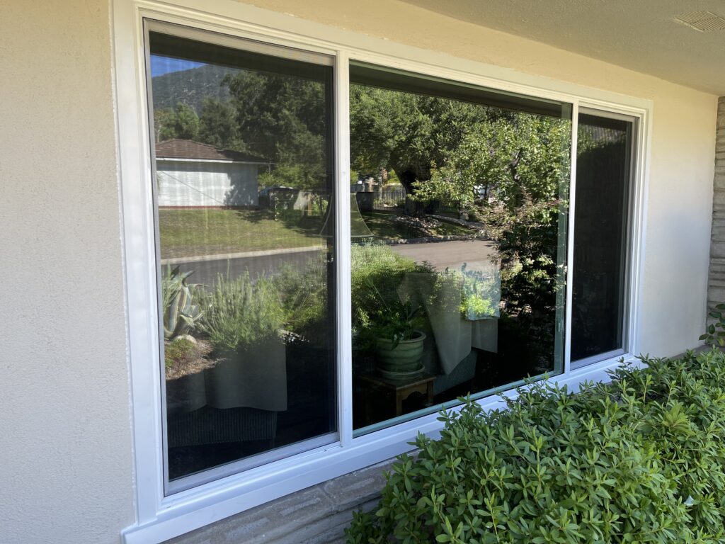 Large newly installed window with white trim