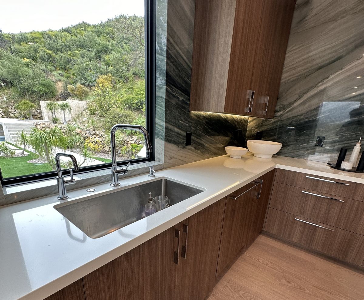 A new kitchen with a window overlooking a garden